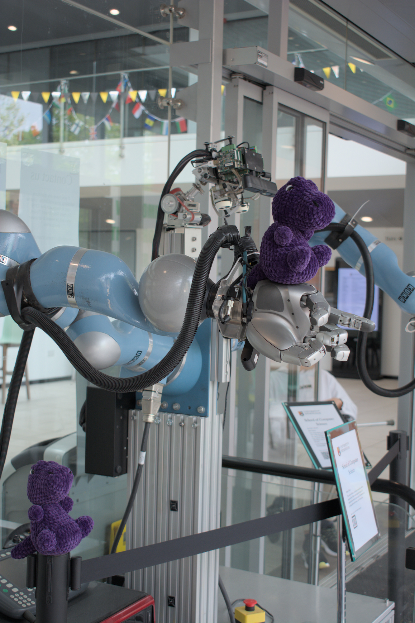 Two TeX's having fun the robots in the CS Atrium